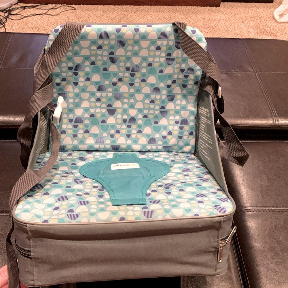 Travel booster seat, teal and gray, removable cushion.